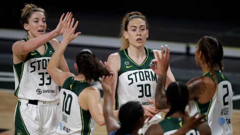 Seattle Storm players, including Katie Lou Samuelson (33) and Breanna Stewart (30), celebrate a basket against the Atlanta Dream. (Ben Margot/AP)