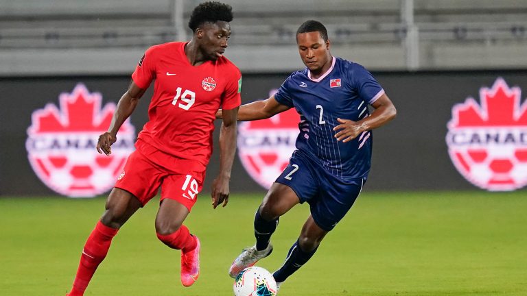 Canada forward Alphonso Davies (19) moves to get past Bermuda defender Eusebio Blankendal (2) during the first half of a World Cup 2022 Group B qualifying soccer match, Thursday, March 25, 2021, in Orlando, Fla. (John Raoux/AP)