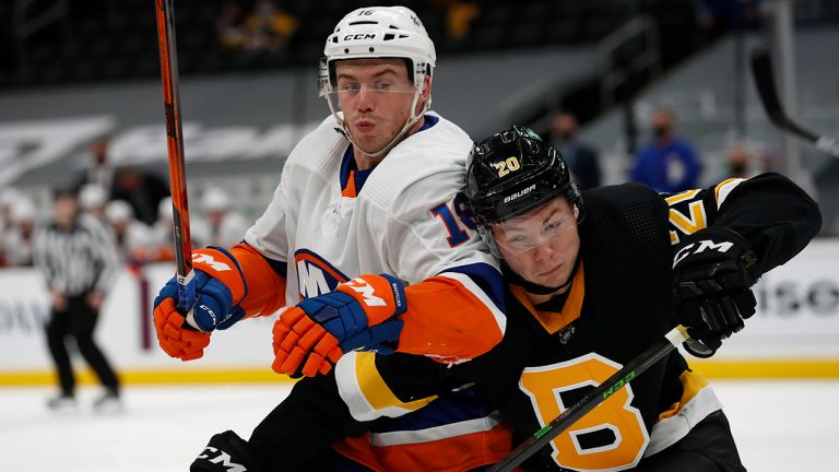 Boston Bruins' Curtis Lazar battles for position with New York Islanders' Anthony Beauvillier during the second period of an NHL hockey game Friday, April 16, 2021, in Boston. (Winslow Townson/AP) 
