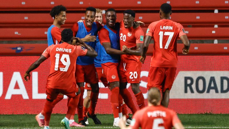 Canada's Jonathan David (20) celebrates with teammates after scoring a goal against Suriname during the second half of a World Cup 2022 Group B qualifying soccer match Tuesday, June 8, 2021, in Bridgeview, Ill. (Kamil Krzaczynski/AP)