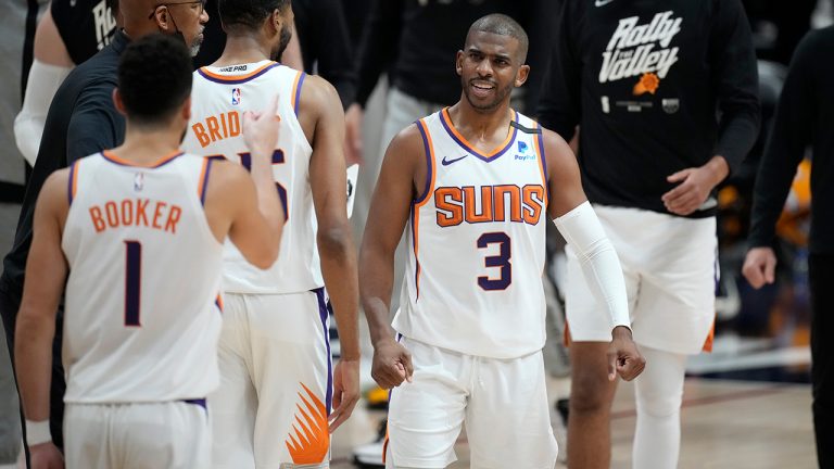 Phoenix Suns guard Chris Paul congratulates teammates during a timeout in the second half of Game 4 of an NBA second-round playoff series against the Denver Nuggets, Sunday, June 13, 2021, in Denver. (David Zalubowski/AP) 