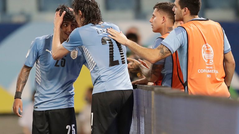 Uruguay's Edinson Cavani (21) celebrates scoring his team's second goal against Bolivia with his teammate Facundo Torres, left, during a Copa America soccer match at Arena Pantanal in Cuiaba, Brazil, Thursday, June 24, 2021. (Andre Penner/AP)