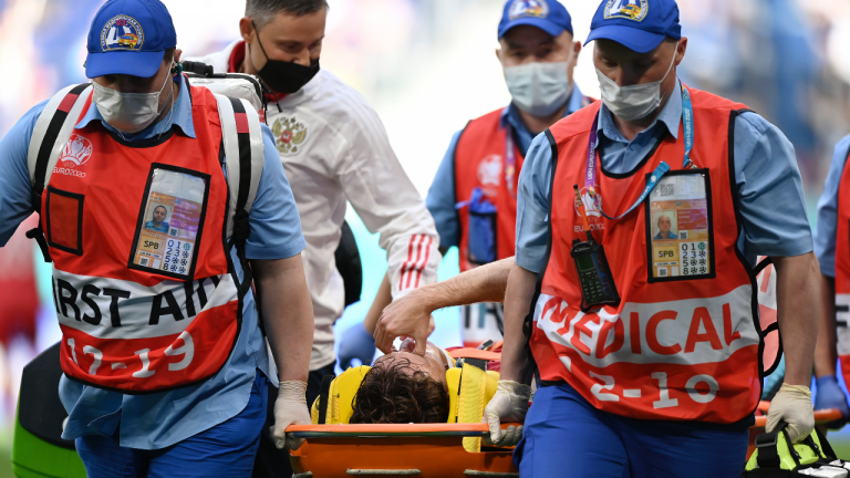 Russia's Mario Fernandes is carried off the pitch during the Euro 2020 soccer championship group B match between Finland and Russia at the Gazprom Arena stadium in St. Petersburg, Russia, Wednesday, June 16, 2021. (Kirill Kudryavtsev / AP) 