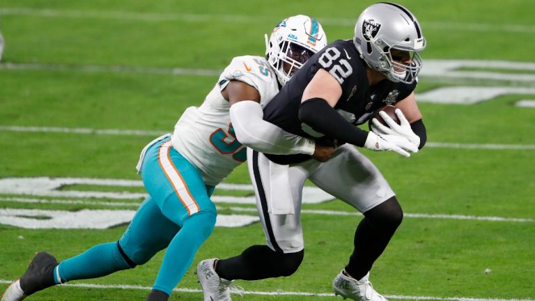 Miami Dolphins outside linebacker Jerome Baker (55) tackles Las Vegas Raiders tight end Jason Witten (82) during the first half of an NFL football game, Saturday, Dec. 26, 2020, in Las Vegas. (Steve Marcus/AP)