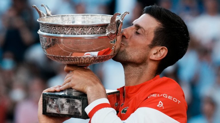 Novak Djokovic kisses the cup after defeating Stefanos Tsitsipas in the French Open Final. (Thibault Camus/AP)