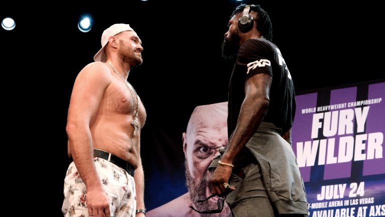 Tyson Fury, left and Deontay Wilder face off at a news conference in Los Angeles. (Richard Vogel/AP)