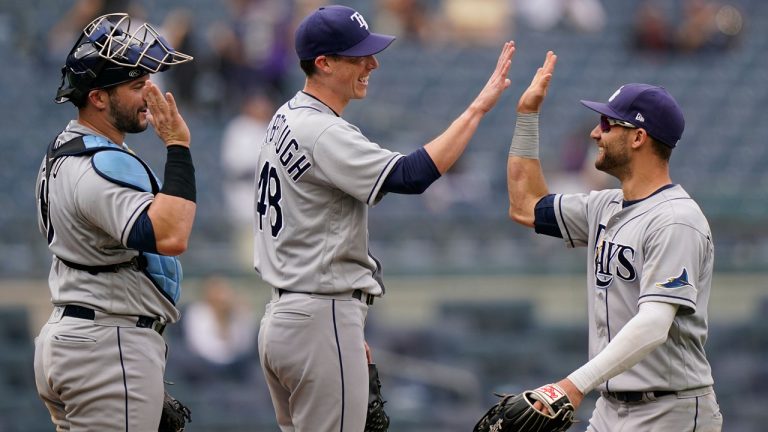 Tampa Bay Rays catcher Mike Zunino, left, pitcher Ryan Yarbrough (48) and center fielder Kevin Kiermaier celebrate after the Rays 9-2 win over the New York Yankees. (Kathy Willens/AP) 
