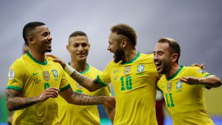 Brazil's Neymar, center, celebrates scoring his side's second goal against Venezuela on a penalty kick with teammates during a Copa America soccer match at the National Stadium. (Eraldo Perez/AP)
