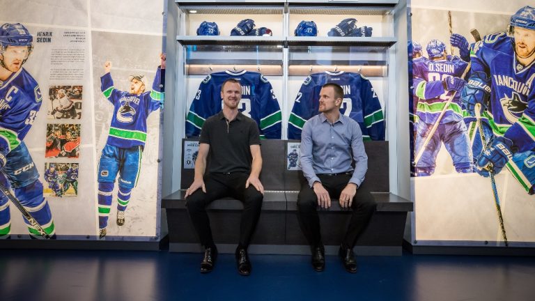 Former Vancouver Canucks' Henrik Sedin, left, and his twin brother Daniel Sedin pose for a photograph in Vancouver, on Monday February 10, 2020. (Darryl Dyck/CP) 