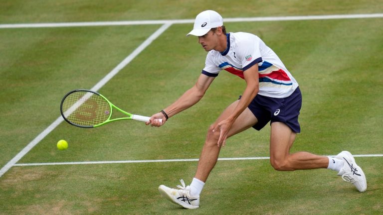 Alex de Minaur of Australia plays a return to Matteo Berrettini of Italy during their semifinal singles tennis match at the Queen's Club tournament in London, Saturday, June 19, 2021. (Kirsty Wigglesworth/AP)