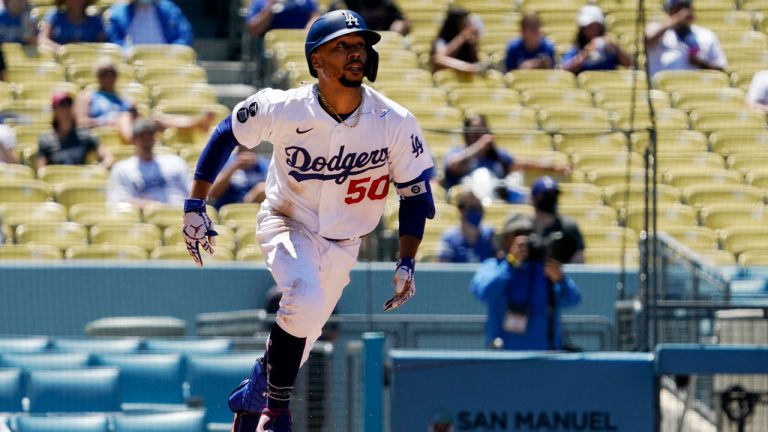 Los Angeles Dodgers' Mookie Betts runs to first after hitting a solo home run during the third inning of a baseball game against the Texas Rangers. (Mark J. Terrill/AP) 