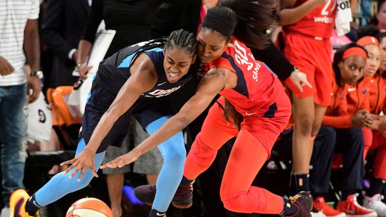 Atlanta Dream guard Tiffany Hayes, left, and Washington Mystics forward LaToya Sanders vie for a ball. (John Amis/AP) 