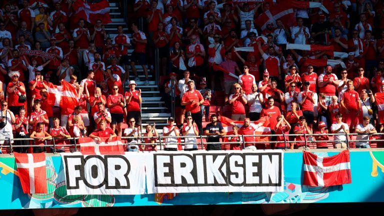 Denmark supporters display a banner for Christian Eriksen, the Danish player who collapsed during the match against Finland last Saturday, June 12, prior to the Euro 2020 soccer championship group B match between Denmark and Belgium, at the Parken stadium in Copenhagen, Thursday, June 17, 2021. (Wolfgang Rattay/Pool via AP)