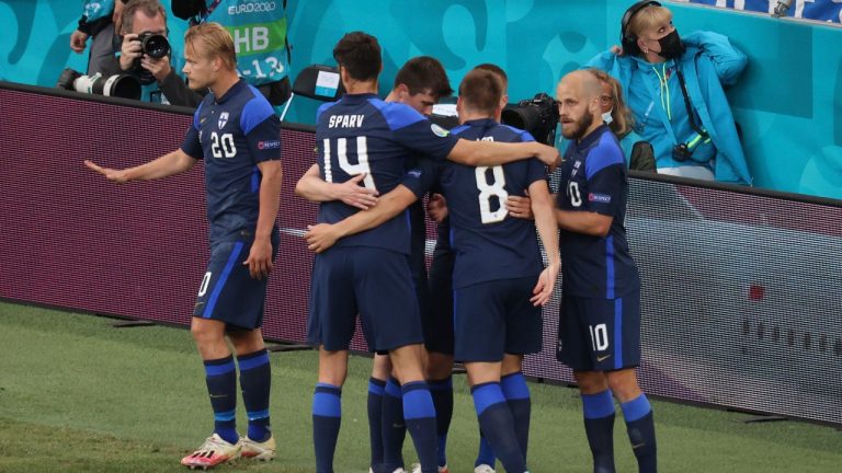 Finland's Joel Pohjanpalo, left, gestures after scoring the opening goal of his team during the Euro 2020 soccer championship group B match between Denmark and Finland at Parken stadium in Copenhagen, Denmark, Saturday, June 12, 2021. (Wolfgang Rattay/Pool via AP) 