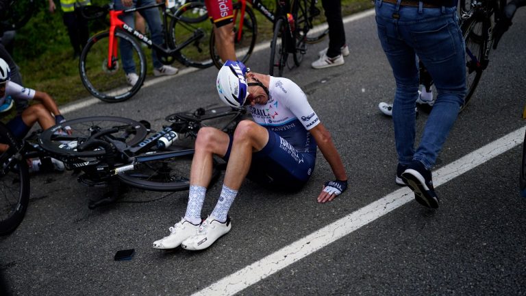 Britain's Chris Froome lays on the road after crashing during the first stage of the Tour de France. (Daniel Cole/AP) 