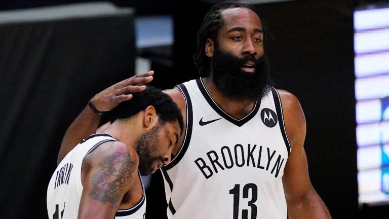 Brooklyn Nets guard Kyrie Irving, left, gets a pat on the head from guard James Harden. (Mark J. Terrill/AP)