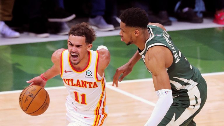 Atlanta Hawks guard Trae Young drives past Milwaukee Bucks defender Giannis Antetokounmpo during Game 1 of the NBA Eastern Conference basketball finals game Wednesday, June 23, 2021, in Milwaukee. (Curtis Compton/Atlanta Journal-Constitution via AP) 