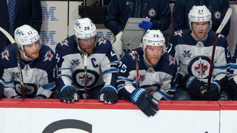 Winnipeg Jets' Adam Lowry, left, watches the final seconds of Game 3 with teammates Blake Wheeler (26), Paul Stastny (25) and Nikolaj Ehlers (27) during third period NHL Stanley Cup playoff hockey action against the Montreal Canadiens, in Montreal, Sunday, June 6, 2021. Montreal beat the Jets to take a 3-0 lead in the series. (Ryan Remiorz/CP)