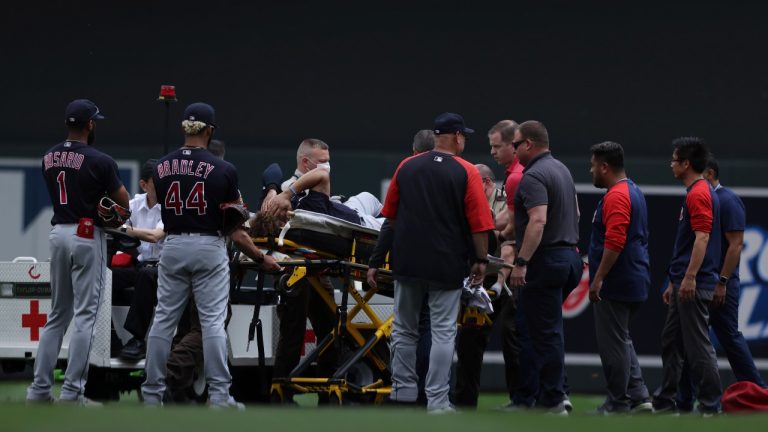 Cleveland's Josh Naylor (22) is surrounded by medical staff after colliding with a teammate during the fourth inning against the Minnesota Twins, Sunday, June 27, 2021, in Minneapolis. (Stacy Bengs/AP)