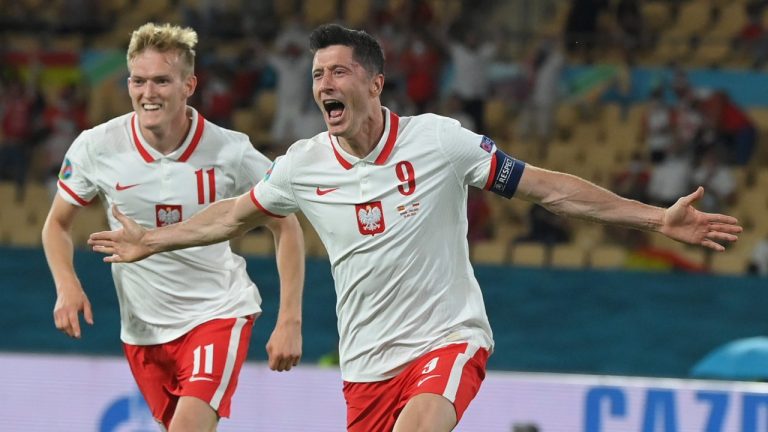 Poland's Robert Lewandowski, right, celebrates after scoring his side's first goal during the Euro 2020 soccer championship group E match between Spain and Poland at La Cartuja stadium in Seville, Spain, Saturday, June 19, 2021. (David Ramos/Pool via AP)