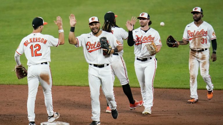 Baltimore Orioles players, from left, Stevie Wilkerson, Anthony Santander, Freddy Galvis, Ryan McKenna and Cedric Mullins celebrate after defeating the Minnesota Twins 7-4 to break a 14-game losing streak during a baseball game, Tuesday, June 1, 2021, in Baltimore. (Julio Cortez/AP) 