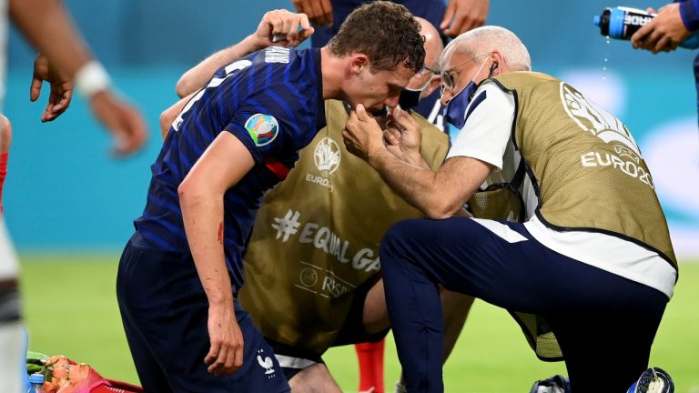 France's Benjamin Pavard gets medical assistance during the Euro 2020 soccer championship group F match between France and Germany at the Allianz Arena stadium in Munich, Tuesday, June 15, 2021. (Matthias Hangst/Pool via AP)