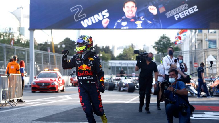 Red Bull driver Sergio Perez of Mexico jubilates after winning the Formula One Grand Prix at the Baku Formula One city circuit in Baku, Azerbaijan, Sunday, June 6, 2021. (Maxim Shemetov, Pool via AP) 
