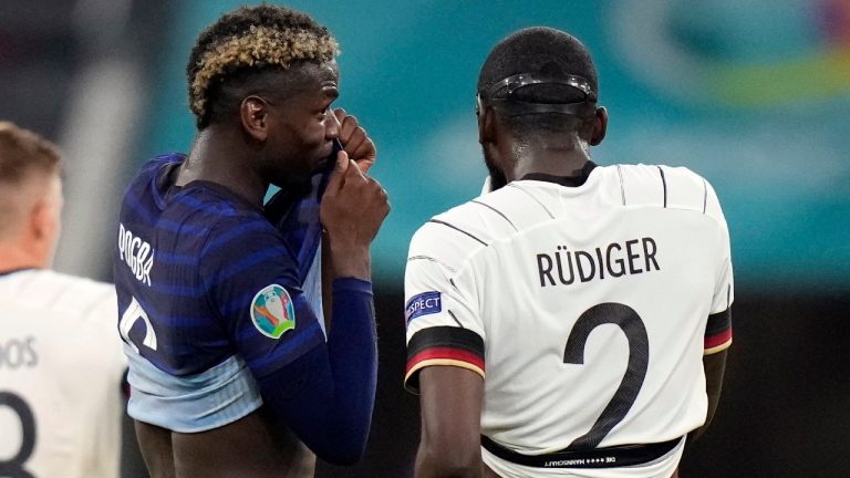 France's Paul Pogba, left, speaks with Germany's Antonio Ruediger during the Euro 2020 soccer championship group F match between France and Germany at the Allianz Arena in Munich, Germany, Tuesday, June 15, 2021. (Matthias Schrader/AP, Pool)