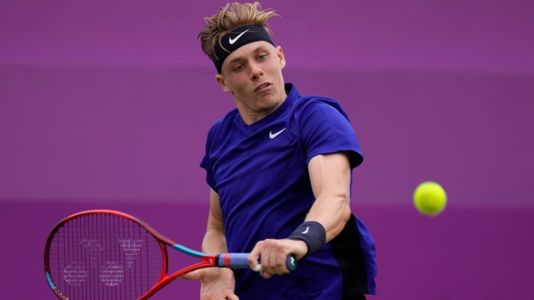 Denis Shapovalov of Canada plays a return to Feliciano Lopez of Spain during their singles tennis match at the Queen's Club tournament in London, Thursday, June 17, 2021. (Kirsty Wigglesworth/AP)