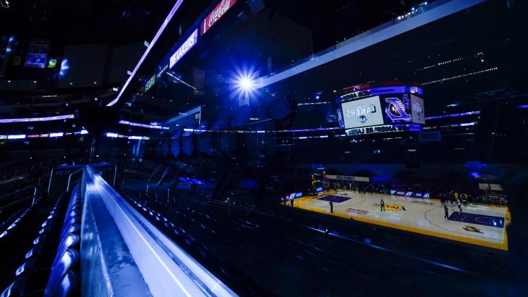 The court is reflected on a glass panel in an empty section of the Staples Center before an NBA basketball game between the Milwaukee Bucks and the Los Angeles Lakers Wednesday, March 31, 2021, in Los Angeles. (Ashley Landis/AP)