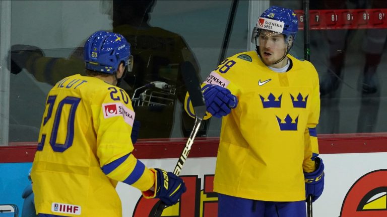 Sweden's Jesper Froden, right, and Lawrence Pilut celebrate a goal during the Ice Hockey World Championship group A match between Switzerland and Sweden at the Olympic Sports Center in Riga, Latvia, Tuesday May 25, 2021. (Roman Koksarov/AP) 