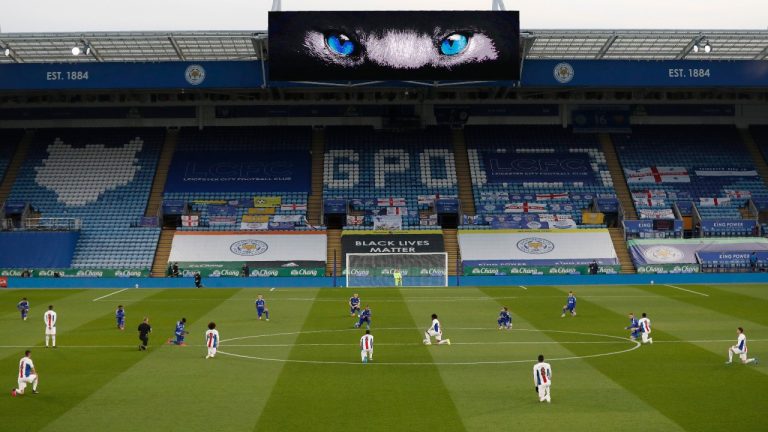 In this Monday, April 26, 2021 file photo, players 'take a knee' in support of the No Room For Racism campaign ahead of the English Premier League soccer match between Leicester City and Crystal Palace at the King Power Stadium in Leicester, England. (Adrian Dennis/Pool via AP, file)