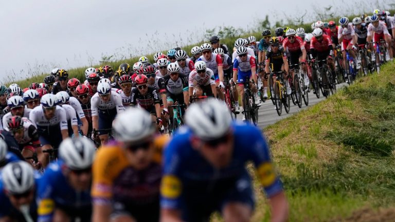 The pack rides during the first stage of the Tour de France cycling race over 197.8 kilometres (122.9 miles) with start in Brest and finish in Landerneau, France, Saturday, June 26, 2021. (Daniel Cole/AP) 