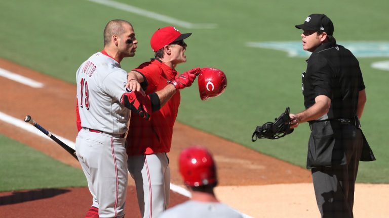 Cincinnati Reds' Joey Votto (19) is held back by manager David Bell, center, while arguing with umpire Ryan Additon after being called out on a checked swing in the first inning of a baseball game against the San Diego Padres, Saturday, June 19, 2021, in San Diego. (Derrick Tuskan/AP)