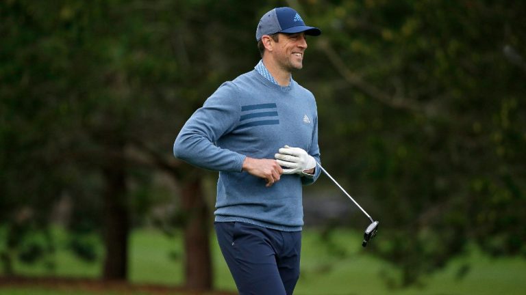 Aaron Rodgers smiles after hitting his approach shot to the 10th green of the Spyglass Hill Golf Course during the second round of the AT&T Pebble Beach National Pro-Am in 2019. (Eric Risberg/AP)