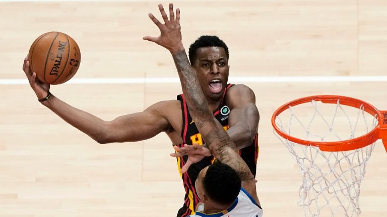 Atlanta Hawks forward Onyeka Okongwu (17) is fouled by Golden State Warriors forward Kent Bazemore (26) as he goes up for a basket in the second half of an NBA basketball game Sunday, April 4, 2021, in Atlanta. (John Bazemore/AP)