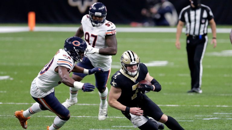 New Orleans Saints quarterback Taysom Hill (7) is pursued by Chicago Bears outside linebacker Barkevious Mingo (50) after catching a pass in the second half of an NFL wild-card playoff football game. (Brett Duke/AP) 