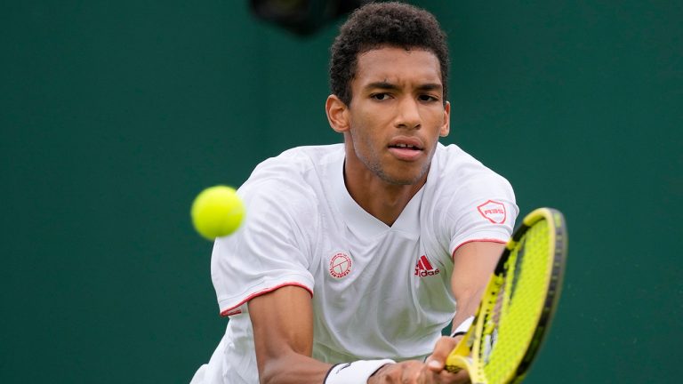 Canada's Felix Auger-Aliassime plays a return to Brazil's Thiago Monteiro during the men's singles first round match on day three of the Wimbledon Tennis Championships in London, Wednesday June 30, 2021. (Kirsty Wigglesworth/AP)