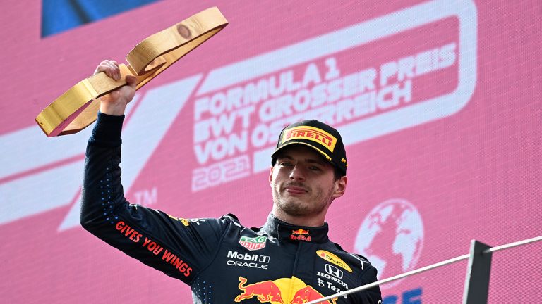 Red Bull driver Max Verstappen of the Netherlands holds his award on the podium after winning the Austrian Formula One Grand Prix at the Red Bull Ring racetrack in Spielberg, Austria, Sunday, July 4, 2021. (Christian Bruna/Pool Photo via AP) 