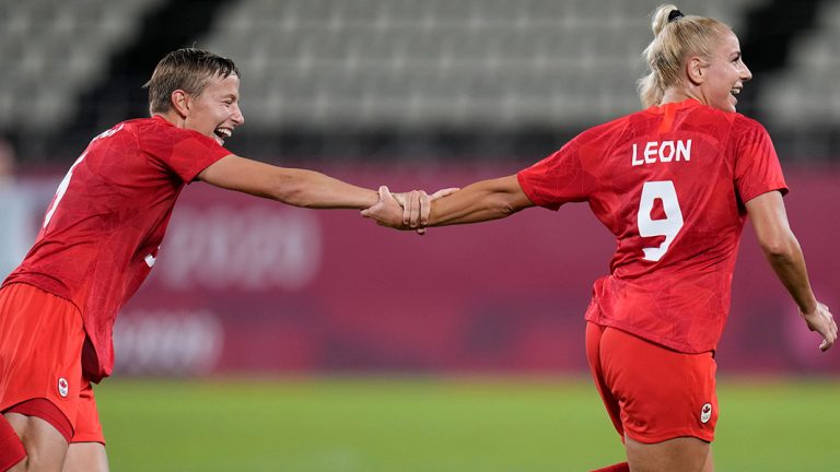 Canada's Adriana Leon, right, celebrates with teammate Quinn after scoring her side's opening goal against Great Britain during a women's soccer match at the 2020 Summer Olympics, Tuesday, July 27, 2021, in Kashima, Japan. (Fernando Vergara/AP) 