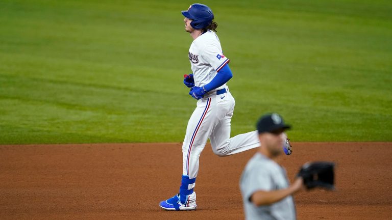 Texas Rangers' Jonah Heim, rear, rounds the bases after hitting a two-run home run off of Seattle Mariners starting pitcher Tyler Anderson during the fifth inning of a baseball game in Arlington, Texas, Saturday, July 31, 2021. (AP Photo/Tony Gutierrez)