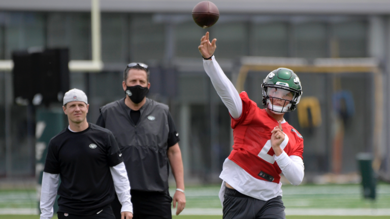 New York Jets first-round draft pick Zach Wilson (2) works out as offensive coordinator Mike Lafleur, left, and passing game specialist Greg Knapp, center, look on during NFL football rookie camp, Friday, May 7, 2021, in Florham Park, N.J. (Bill Kostroun / AP) 