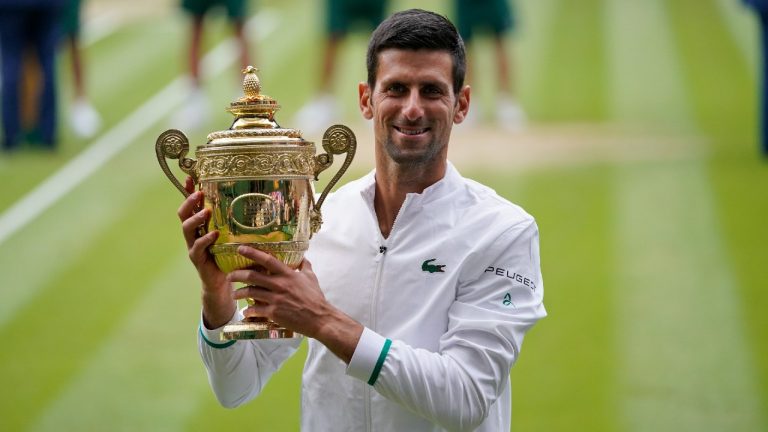 Serbia's Novak Djokovic holds the winner's trophy after his victory over Italy's Matteo Berrettini during the men's singles final match on day thirteen of the Wimbledon Tennis Championships in London, Sunday, July 11, 2021. (Alberto Pezzali/AP)