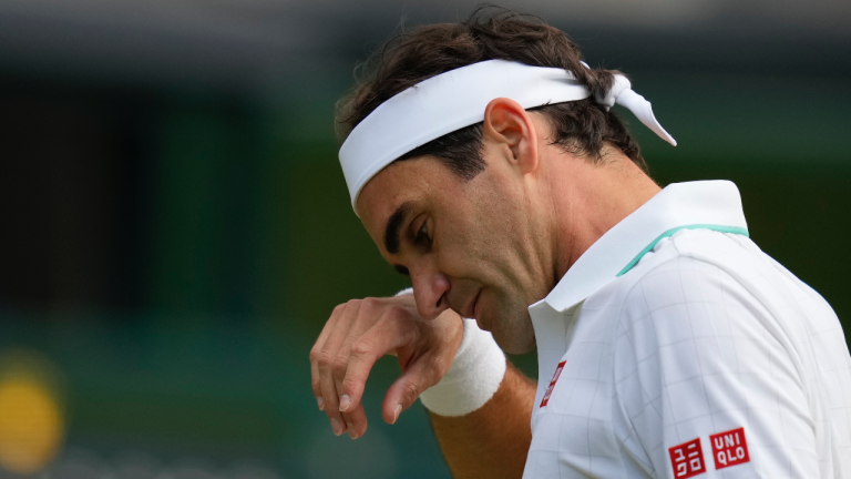 Switzerland's Roger Federer wipes his brow during the men's singles quarterfinals match against Poland's Hubert Hurkacz on day nine of the Wimbledon Tennis Championships. (Kirsty Wigglesworth / AP)