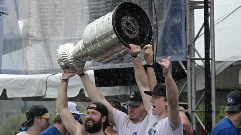 Tampa Bay Lightning right wing Nikita Kucherov, left, defenseman Mikhail Sergachev, center, and goaltender Andrei Vasilevskiy hoist the Stanley Cup during the NHL hockey Stanley Cup champions' championship celebration after their boat parade, Monday, July 12, 2021, in Tampa, Fla. (Phelan M. Ebenhack / AP)