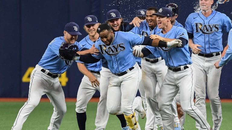 Tampa Bay Rays teammates celebrate with Yandy Diaz, centre. (Steve Nesius/AP)