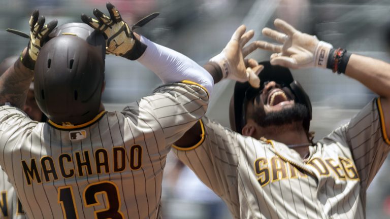 San Diego Padres third baseman Manny Machado (13) and Padres shortstop Fernando Tatis Jr. celebrate a two-run home run against the Atlanta Braves in the first game of a baseball doubleheader Wednesday, July 21, 2021, in Atlanta. (Hakim Wright Sr./AP)