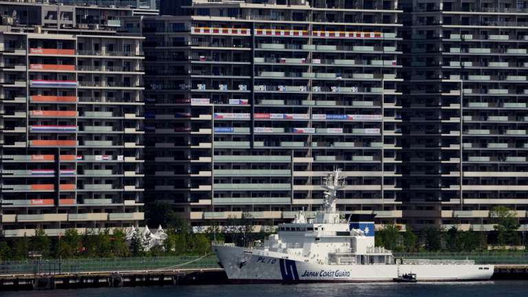 National banners hang from balconies at an athlete's village as Tokyo prepares for the 2020 Summer Olympics, Sunday, July 18, 2021. The pandemic-delayed games open on July 23 without spectators at most venues. (Charlie Riedel / AP)