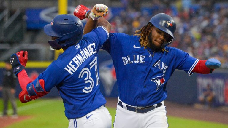 Toronto Blue Jays' Teoscar Hernandez, left, celebrates his two-run home run with Vladimir Guerrero Jr. during the third inning of the team's baseball game against the Texas Rangers in Buffalo, N.Y., Friday, July 16, 2021. (Adrian Kraus/AP)