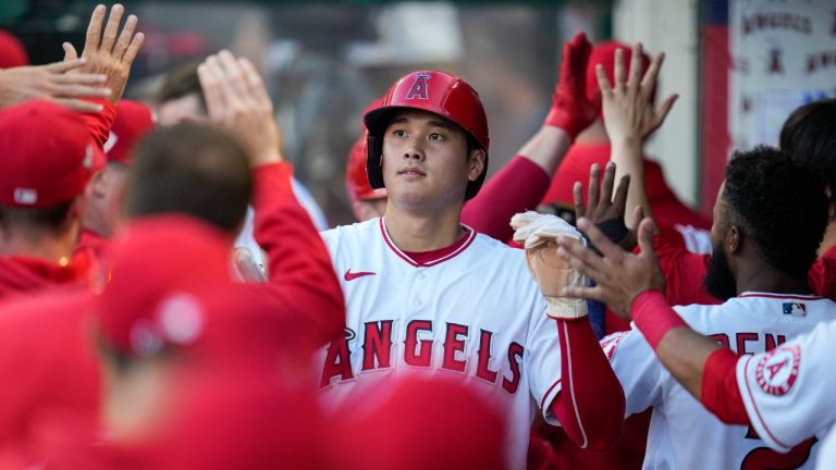 Los Angeles Angels' Shohei Ohtani (17) celebrates in the dugout after scoring off of a home run hit by Max Stassi during the first inning of a baseball game Tuesday, July 6, 2021, in Anaheim, Calif. (Ashley Landis/AP)